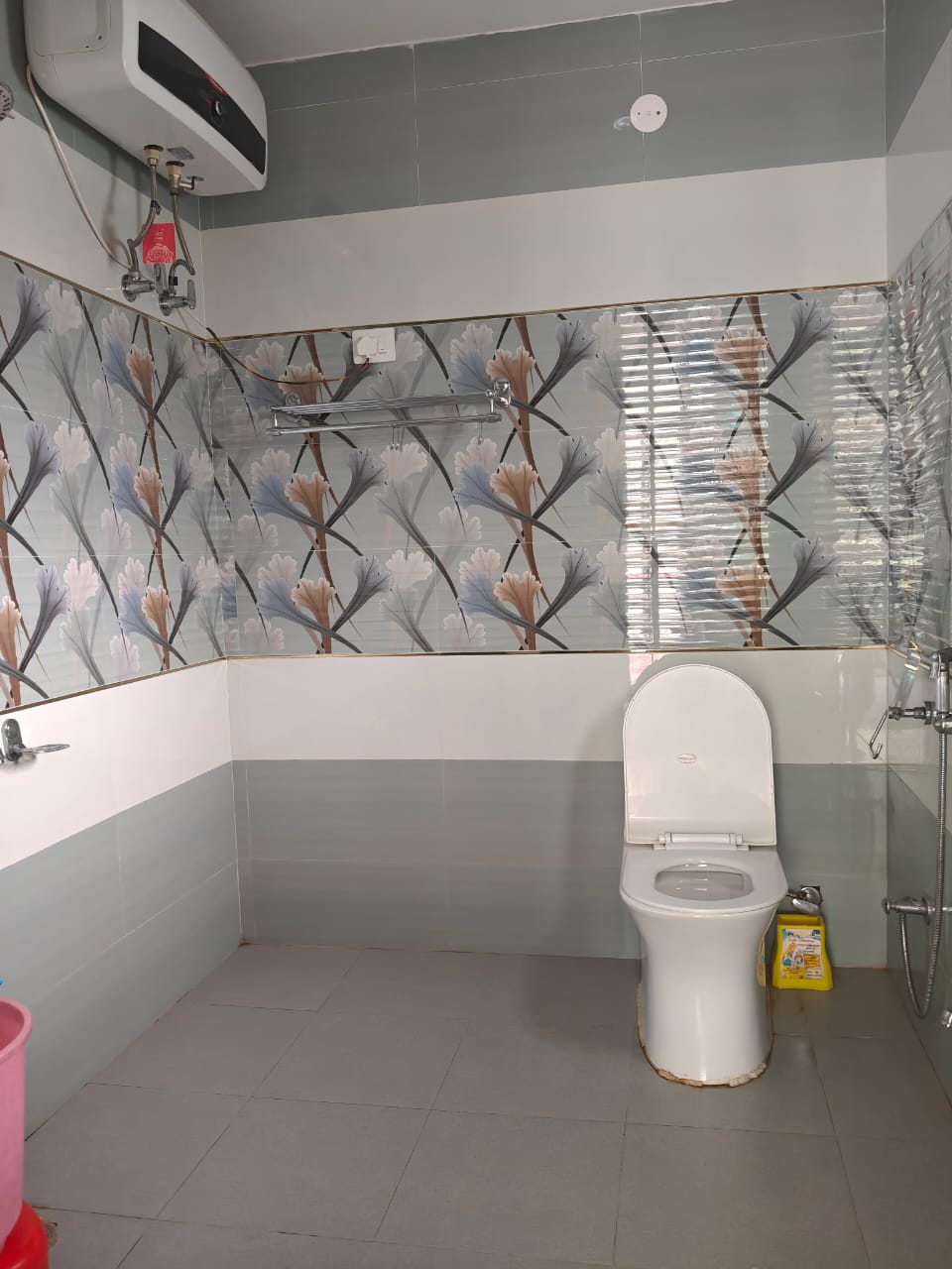 Tiled bathroom with western toilet